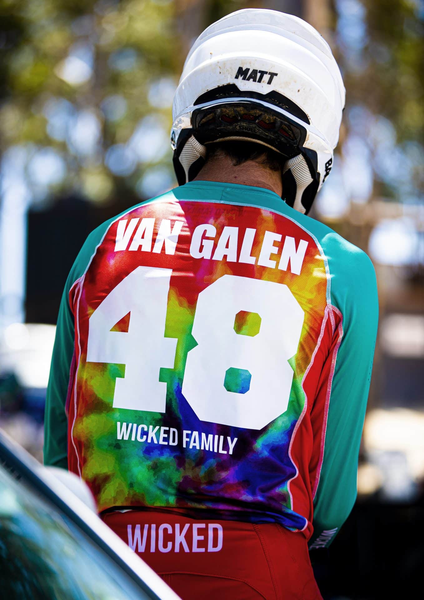 Mx rider in a tiedye jersey with ID kit on the back