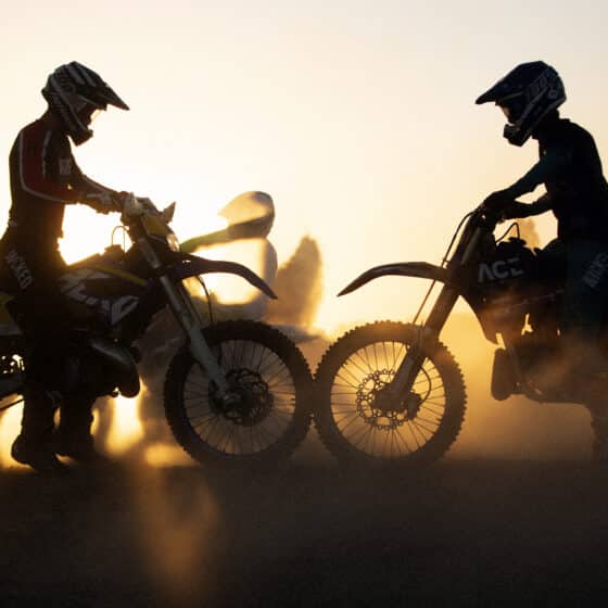 dirt bike riders in the sunset